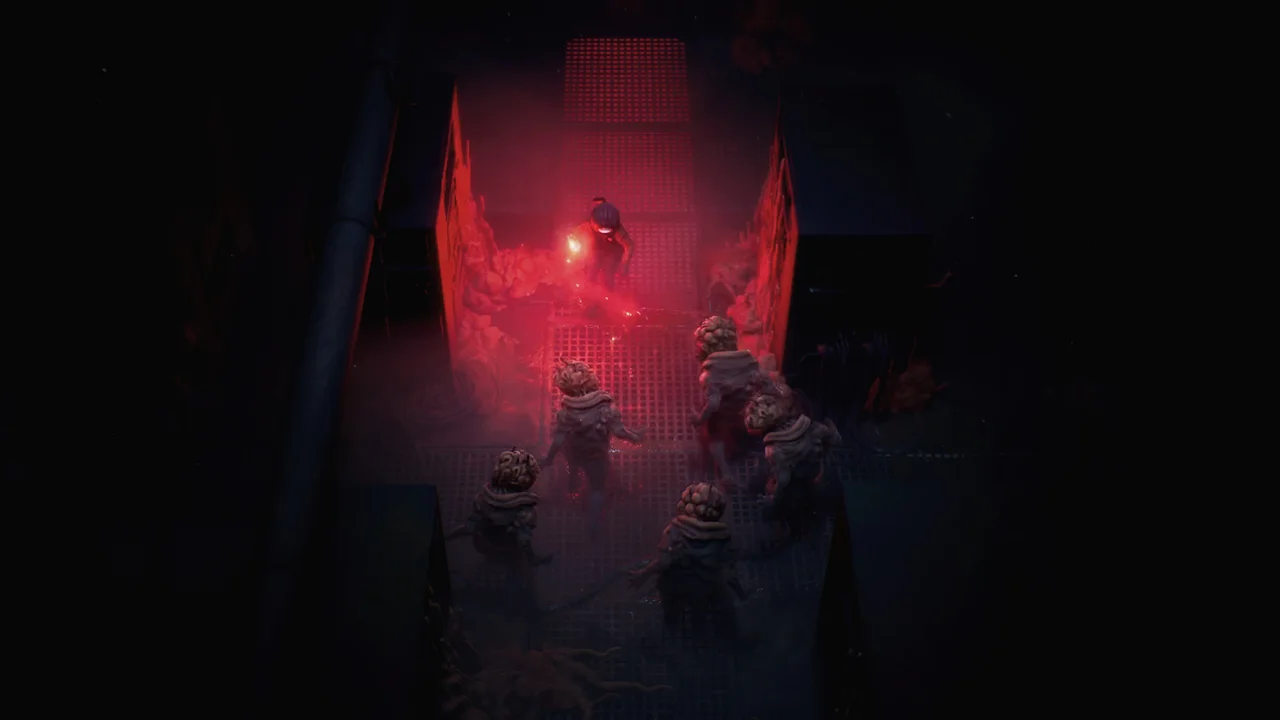 A red light illuminates Cel and nearby creatures in a narrow corridor.